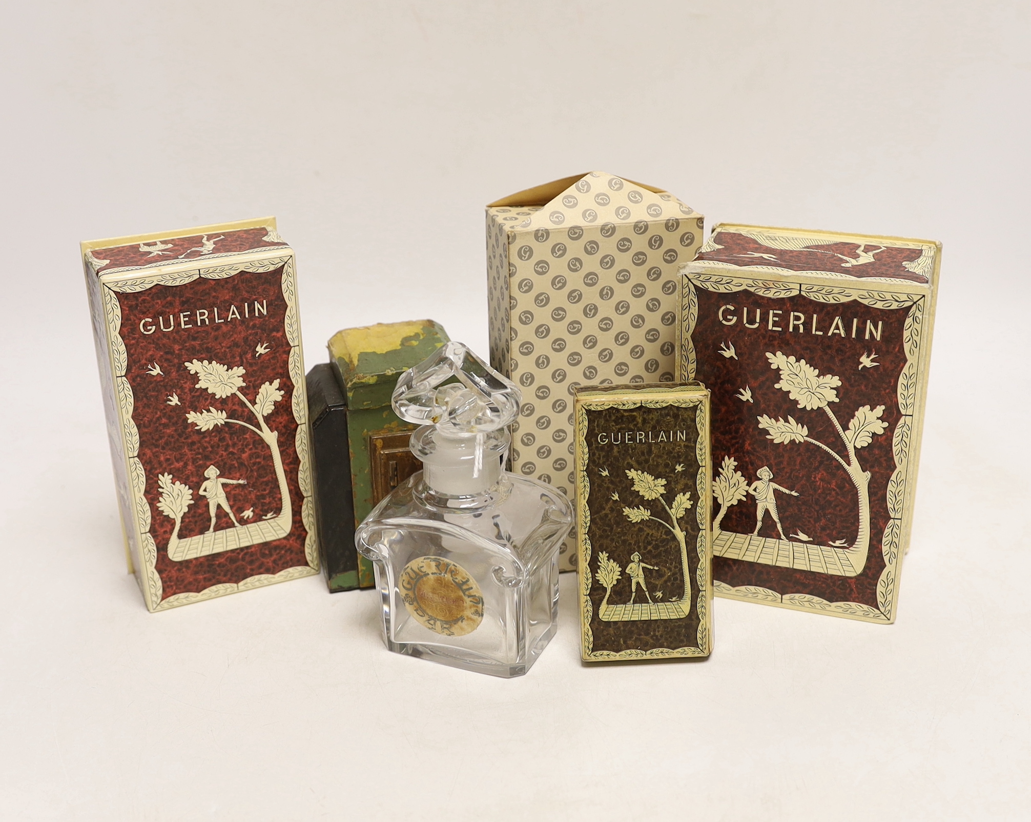 A collection of Guerlain perfume bottles, some with cases, including ‘Liu’